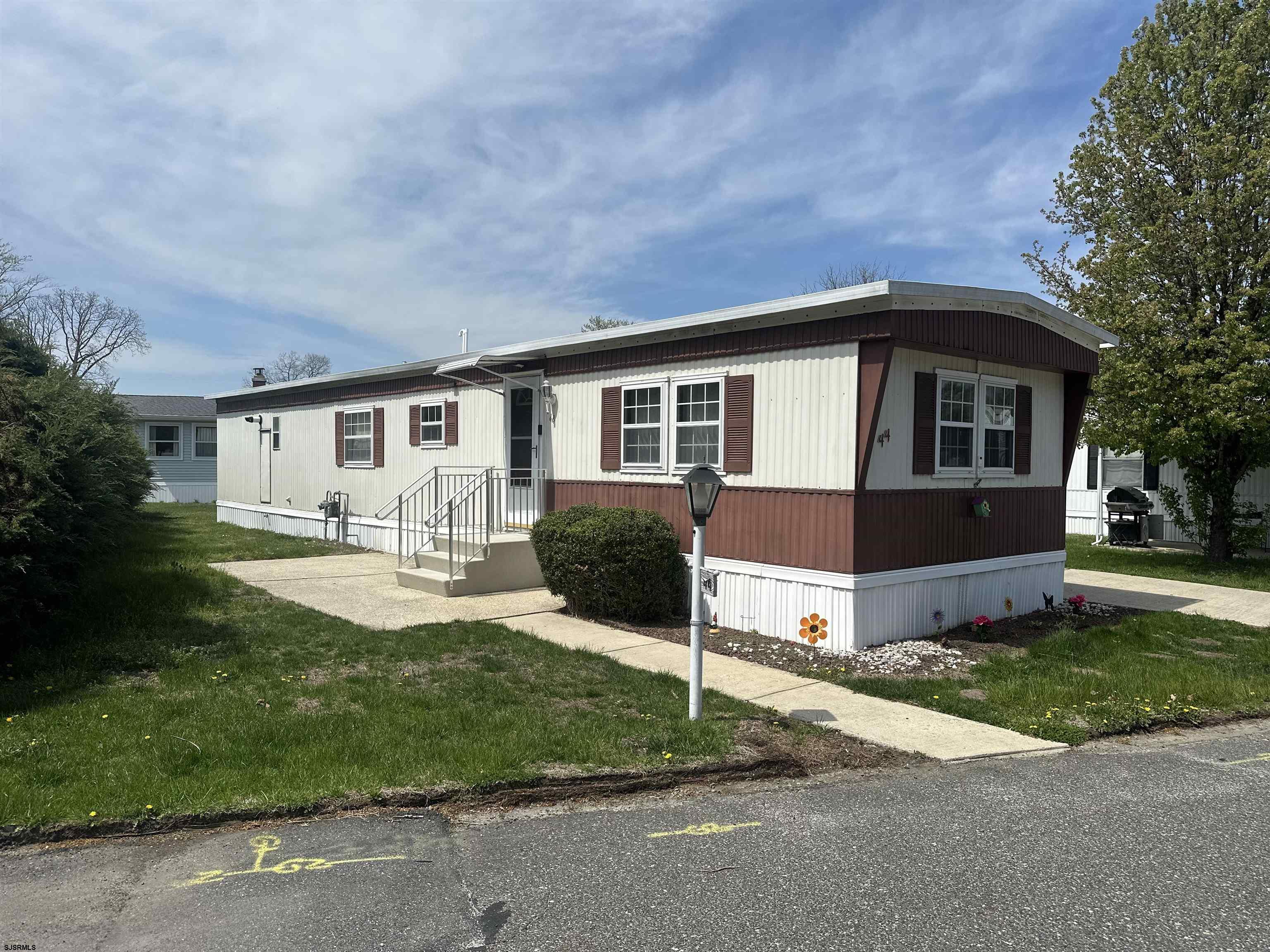 6215 Delilah Road Egg Harbor Township, NJ 08234 - Photo 1 of 18 a front view of a house with a garden and yard
