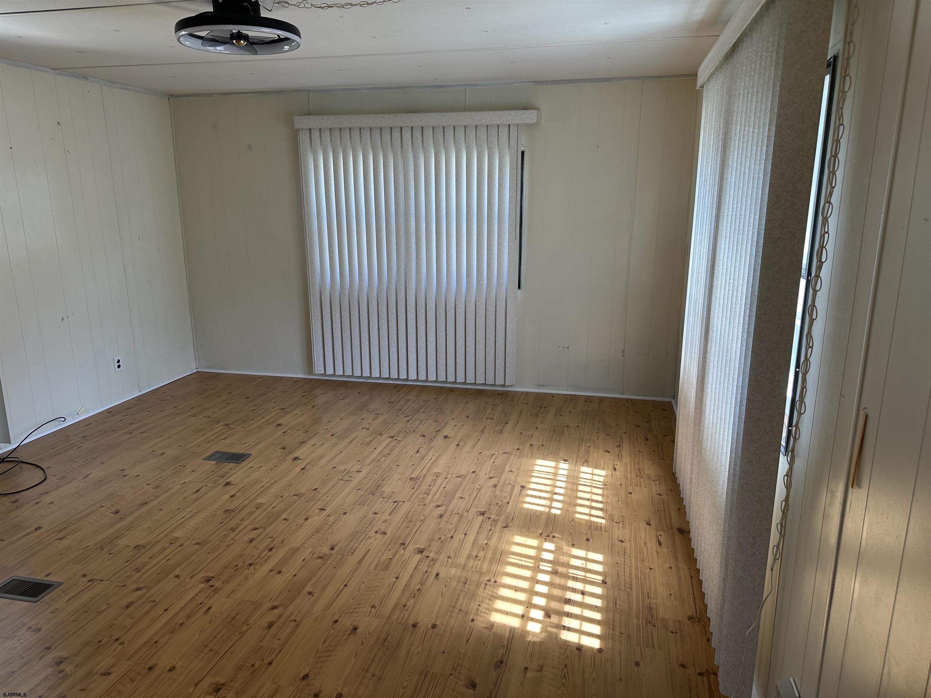 6215 Delilah Road Egg Harbor Township, NJ 08234 - Photo 15 of 18 a view of an empty room with wooden floor