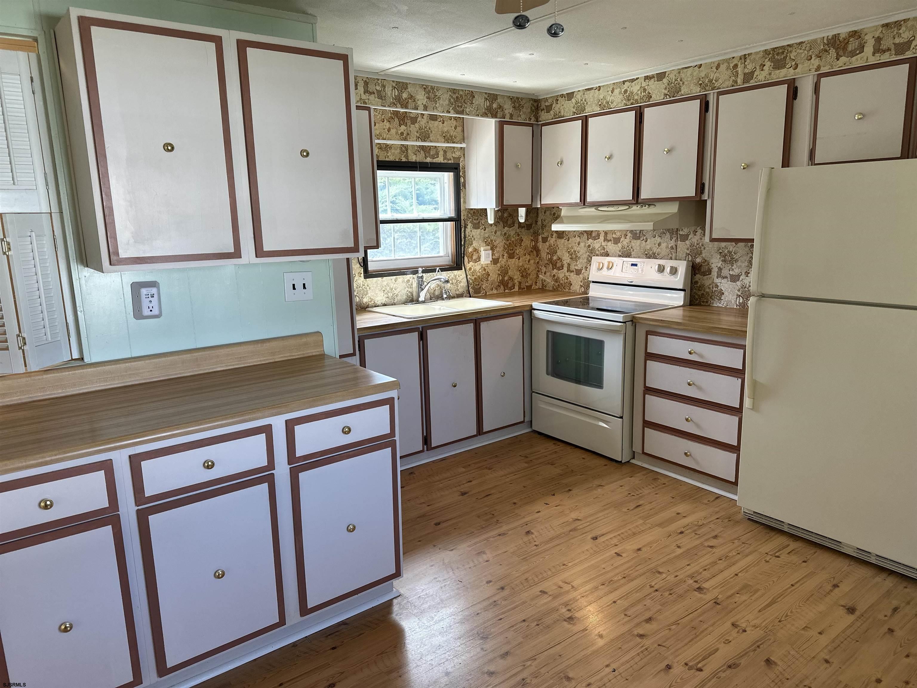 6215 Delilah Road Egg Harbor Township, NJ 08234 - Photo 5 of 18 a kitchen with stainless steel appliances a stove sink and cabinets