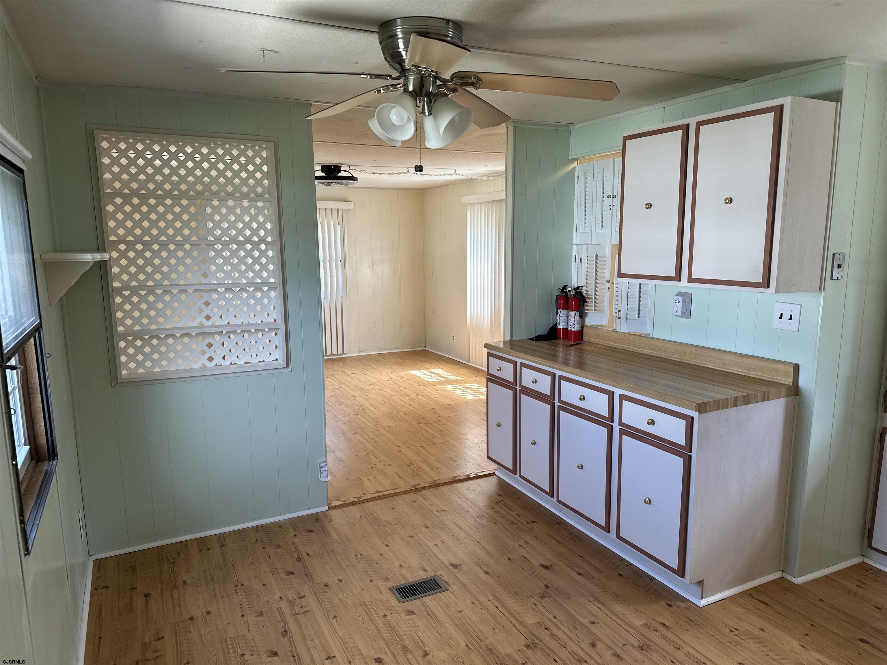6215 Delilah Road Egg Harbor Township, NJ 08234 - Photo 8 of 18 a kitchen with stainless steel appliances granite countertop a stove a sink and a refrigerator with wooden floor