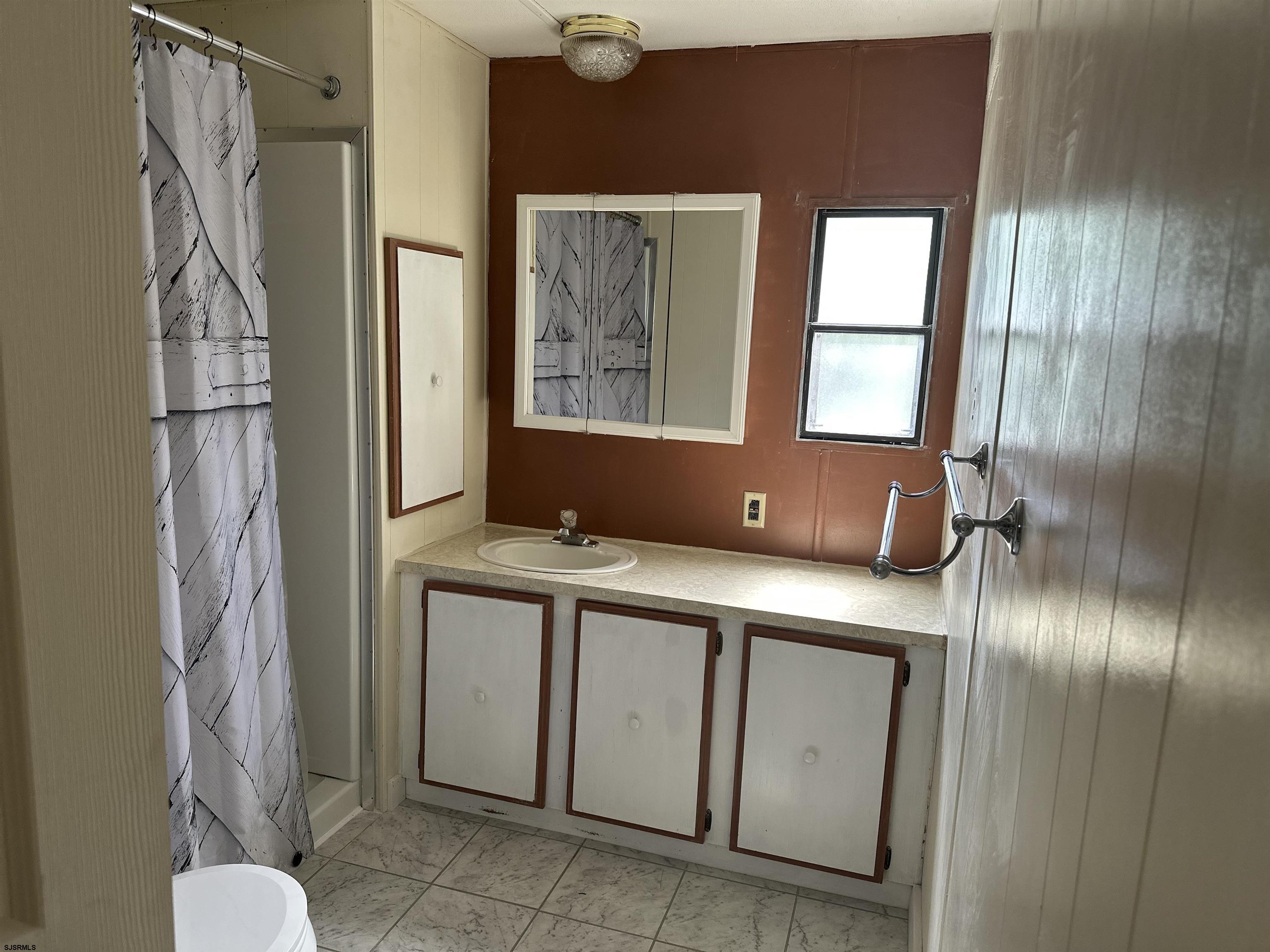 6215 Delilah Road Egg Harbor Township, NJ 08234 - Photo 10 of 18 a bathroom with a sink and a mirror