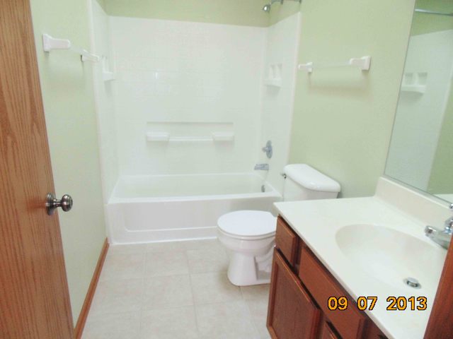 637 Deames Street Plano, IL 60545 - Photo 14 of 18 a bathroom with a sink a toilet and shower