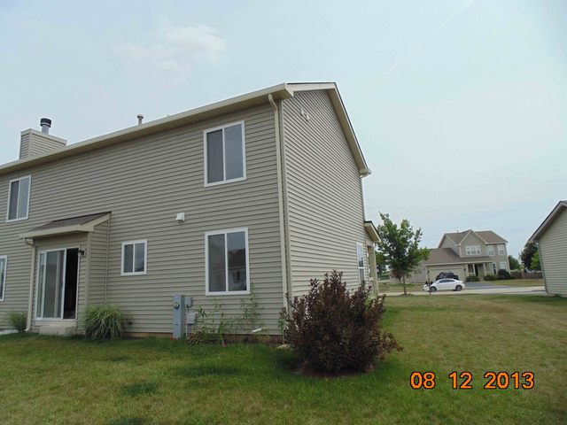 637 Deames Street Plano, IL 60545 - Photo 3 of 18 a front view of a house with garden