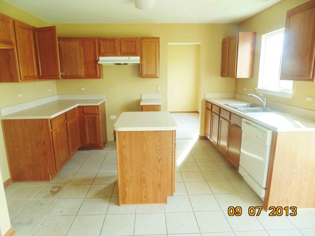 637 Deames Street Plano, IL 60545 - Photo 8 of 18 a kitchen with stainless steel appliances a stove a sink and a microwave