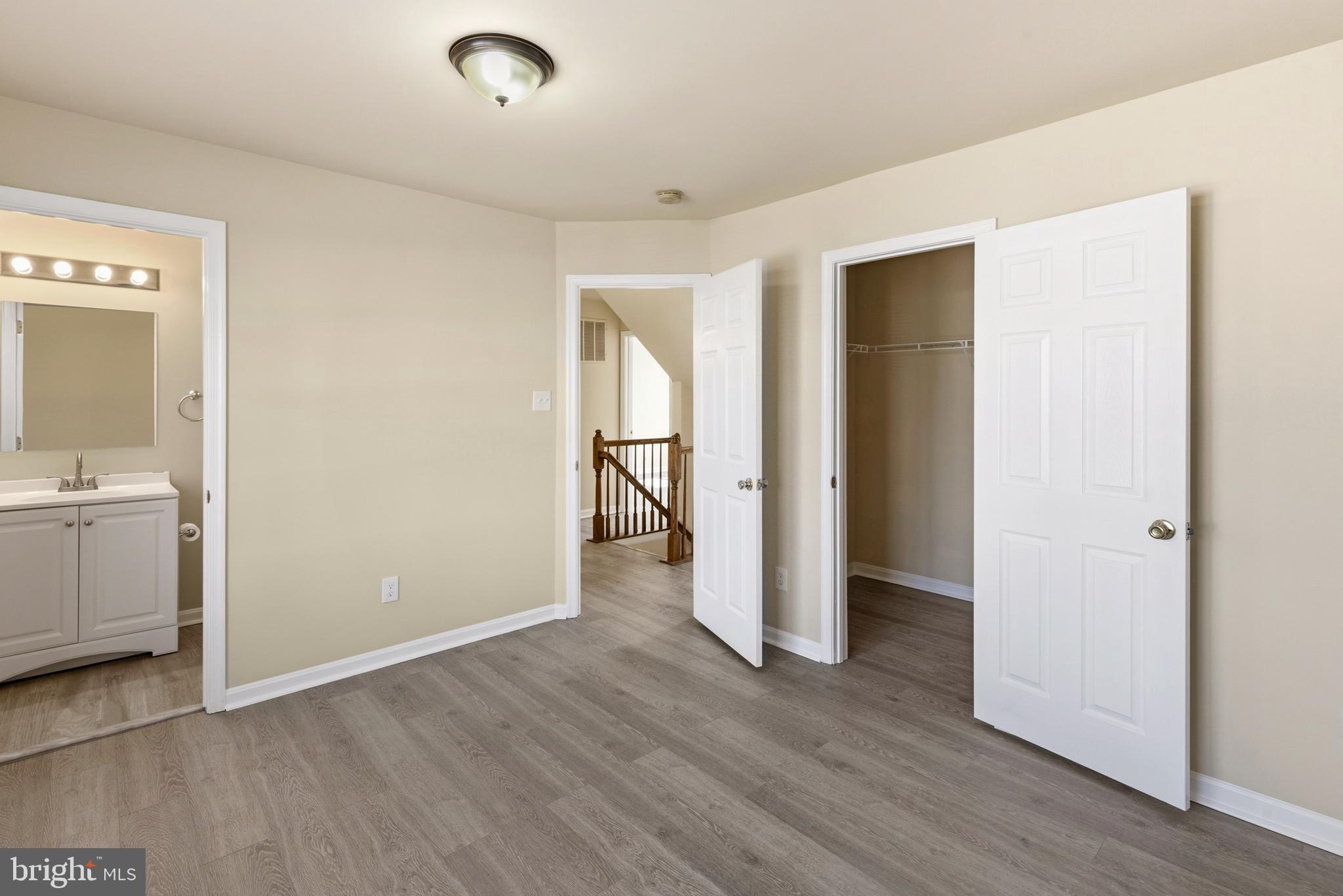 4704 Denview Way Baltimore, MD 21206 - Photo 15 of 42 a view of an empty room with wooden floor and a bathroom