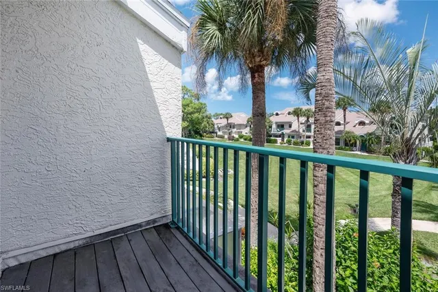 a view of a balcony with wooden fence
