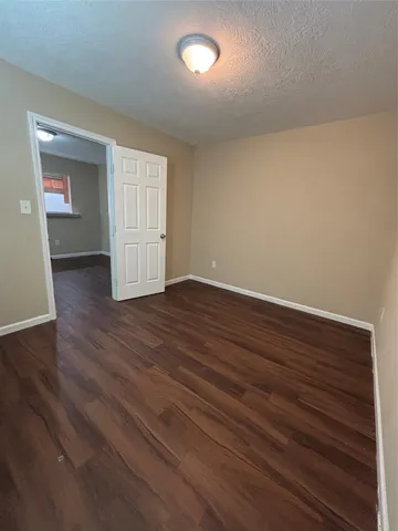 a view of an empty room and wooden floor