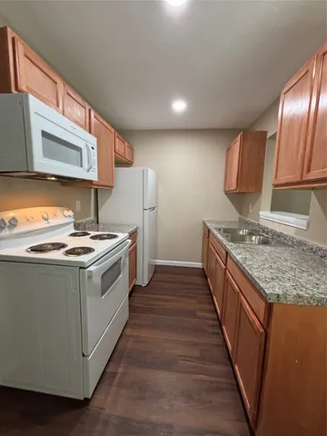a kitchen with a stove a sink and a refrigerator