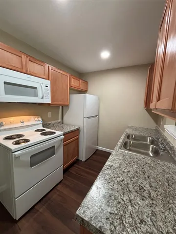 a kitchen with stainless steel appliances granite countertop a stove and a sink