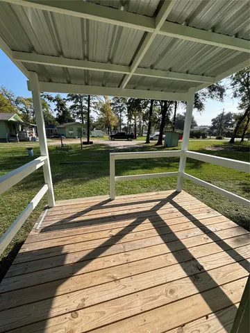 a view of a room with wooden floor and window
