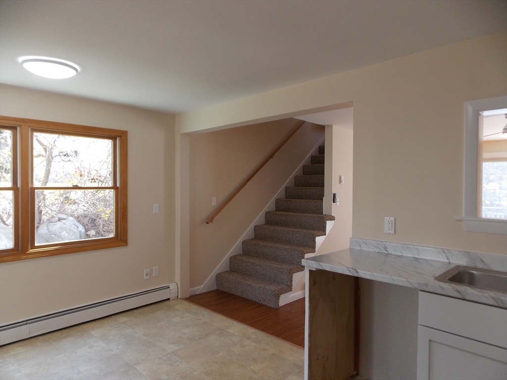 196 Main Street, Unit A Rockport, MA 01966 - Photo 11 of 36 a view of entryway and hall with wooden floor