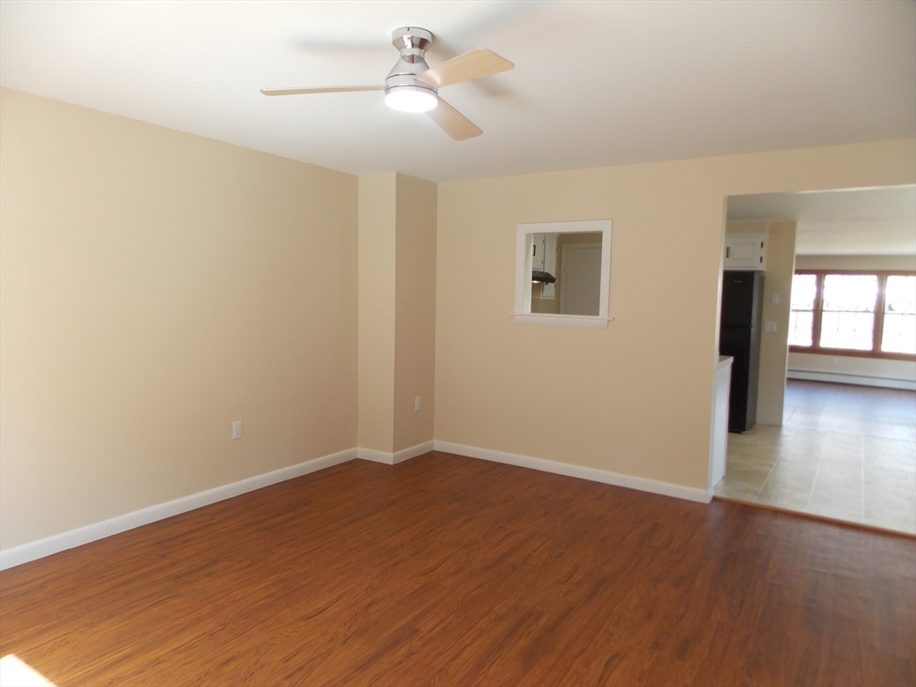196 Main Street, Unit A Rockport, MA 01966 - Photo 13 of 36 a view of empty room with wooden floor