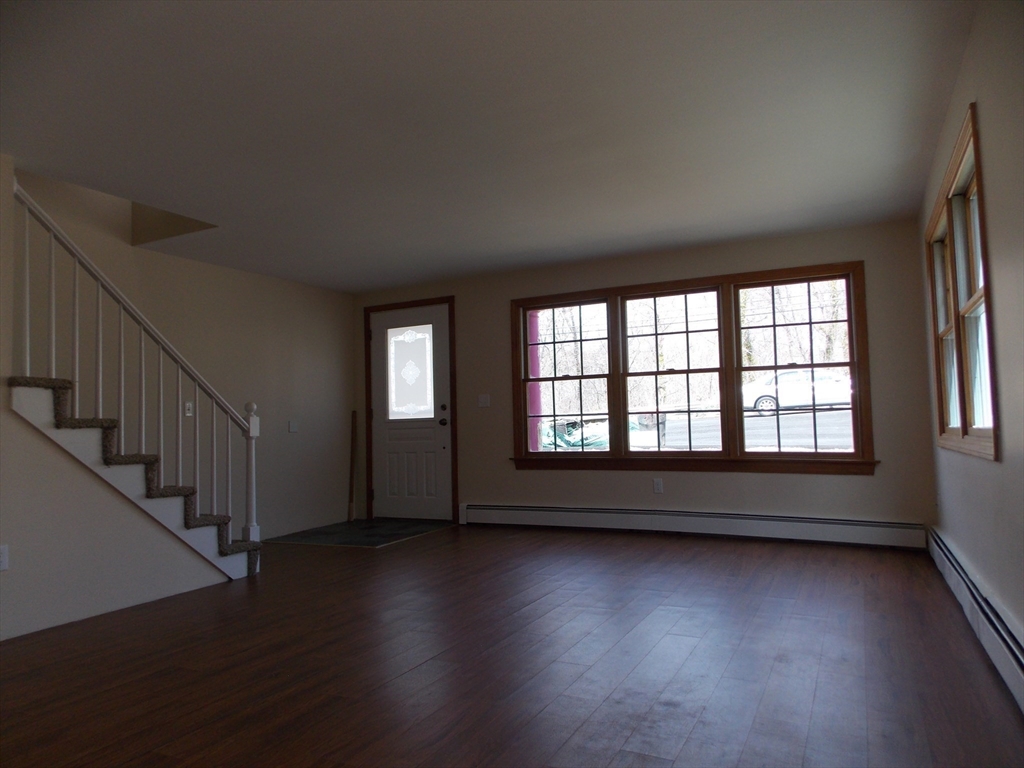 196 Main Street, Unit A Rockport, MA 01966 - Photo 2 of 36 wooden floor in an empty room with a window