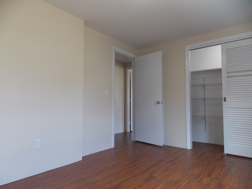 196 Main Street, Unit A Rockport, MA 01966 - Photo 23 of 36 a view of an empty room with wooden floor and closet