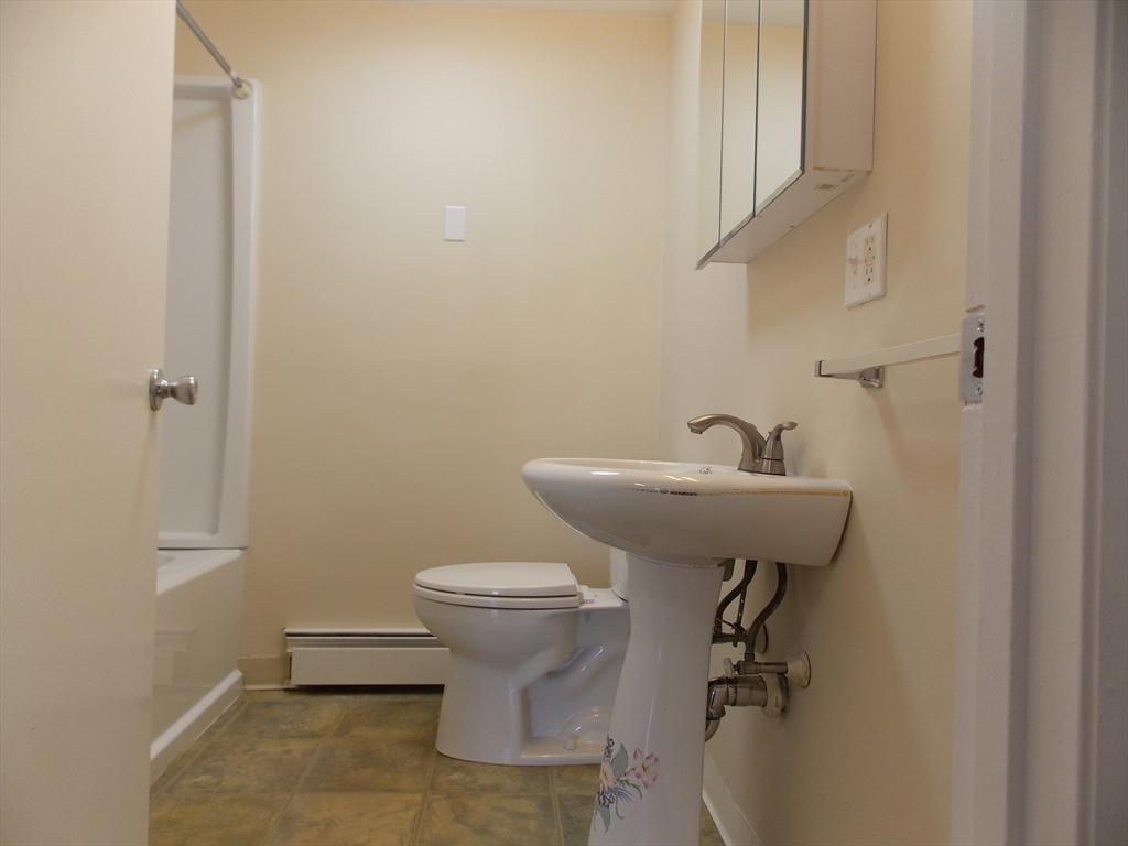 196 Main Street, Unit A Rockport, MA 01966 - Photo 26 of 36 a bathroom with a sink toilet and a mirror