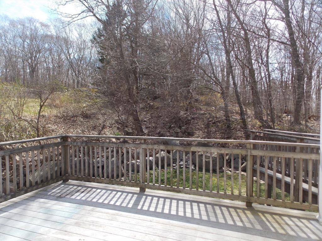196 Main Street, Unit A Rockport, MA 01966 - Photo 31 of 36 a view of a balcony with wooden floor and fence