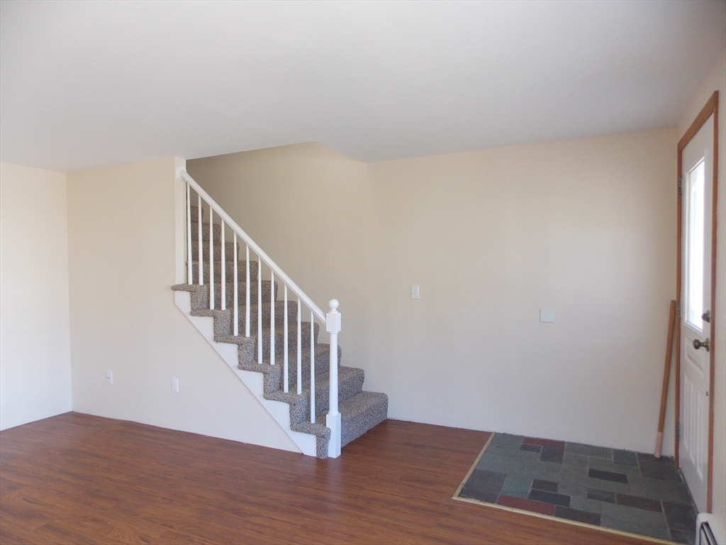 196 Main Street, Unit A Rockport, MA 01966 - Photo 6 of 36 a view of a hallway with wooden floor