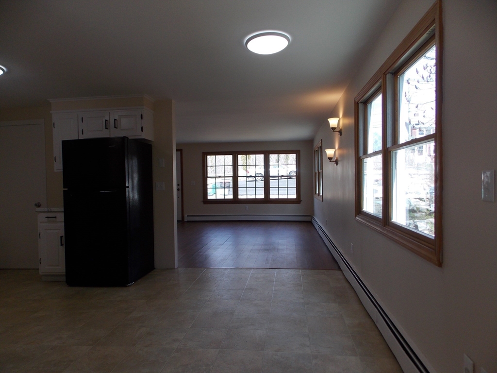 196 Main Street, Unit A Rockport, MA 01966 - Photo 8 of 36 wooden floor in an empty room with a window