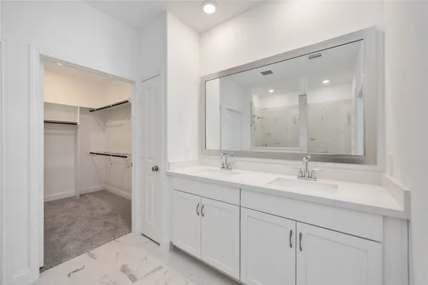 a bathroom with a double vanity sink mirror and double