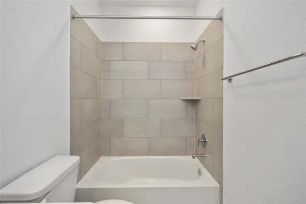 a bathroom with a shower and toilet