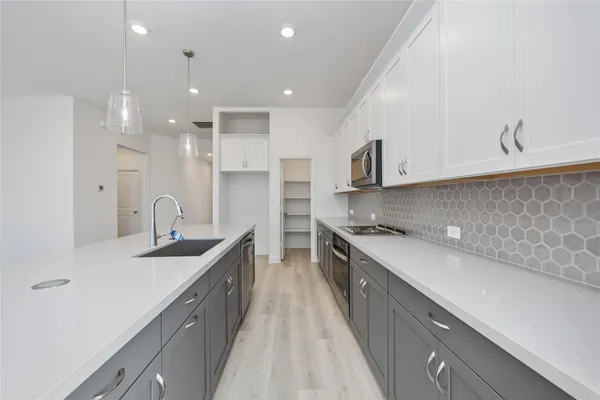 a kitchen with stainless steel appliances granite countertop a sink and stove