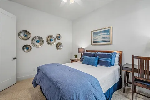 a bedroom with a bed and a table with a bookshelf
