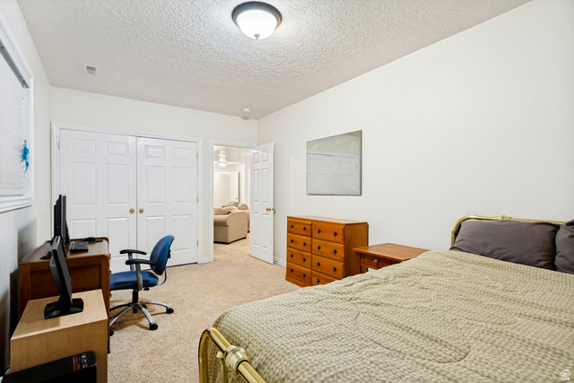 298 North Canyon Road Bountiful, UT 84010 - Photo 49 of 57 Carpeted room featuring white walls, a single window with blinds, and white bi-fold closet doors