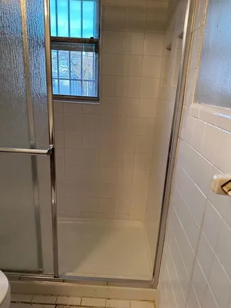 a bathroom with a glass door shower
