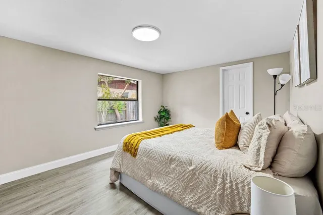 a bedroom with a bed and a window