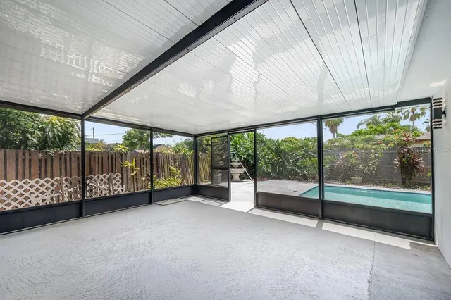 an empty room with large windows