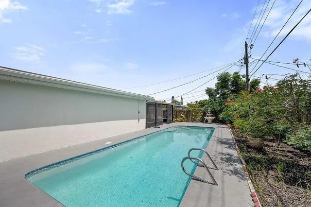a view of a house with a big yard and potted plants