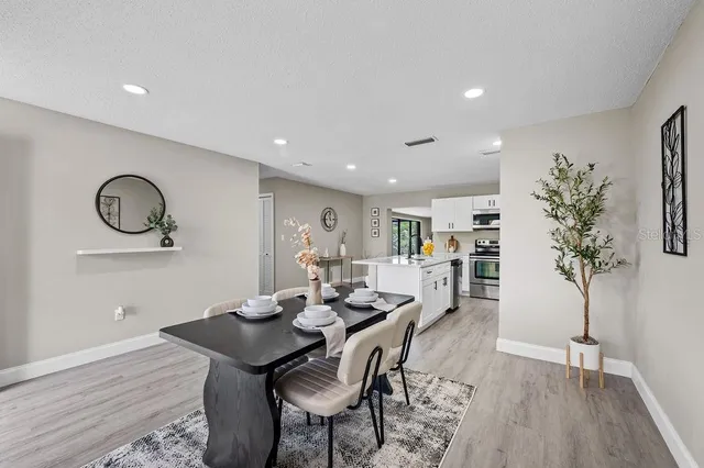 a view of a dining room with furniture and wooden floor