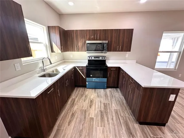 a view of walk in closet with wooden floor