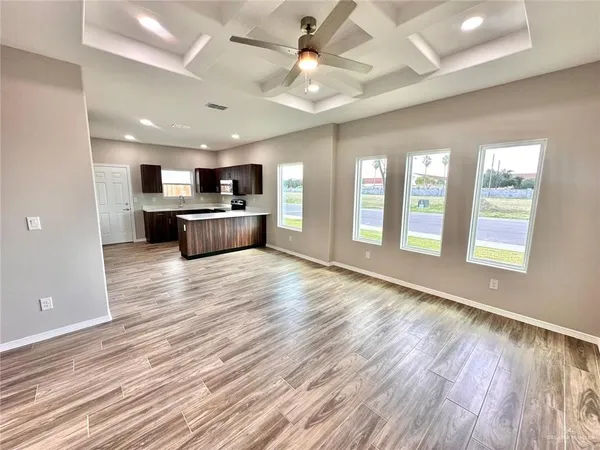 a view of a hallway with wooden floor and closet