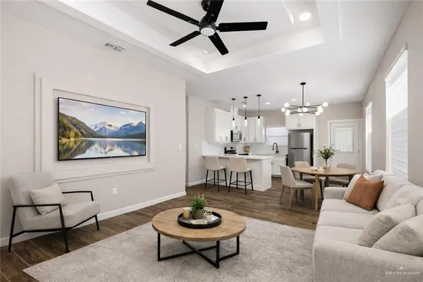 a living room with furniture and a chandelier