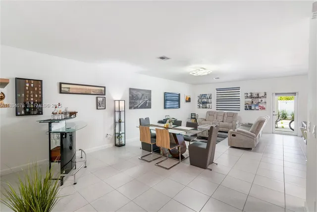a living room with furniture and large window