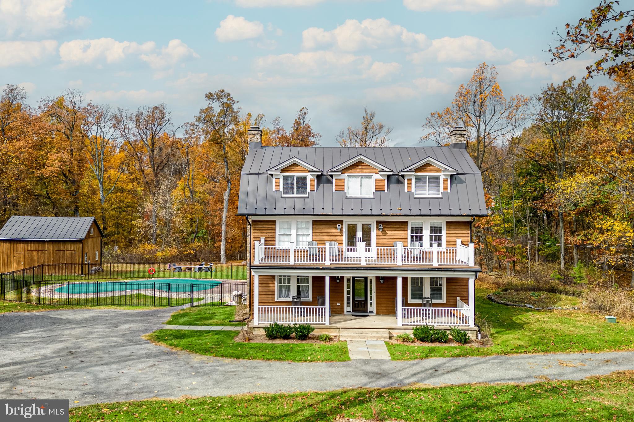 17345 Raven Rocks Road Bluemont, VA 20135 - Photo 6 of 99 a front view of a house with a garden and trees