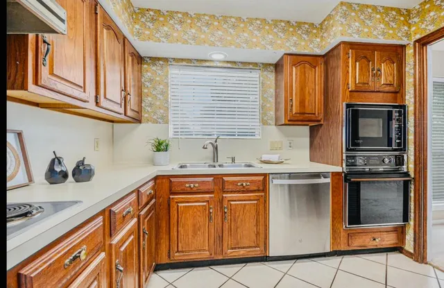 a kitchen with stainless steel appliances granite countertop a sink and cabinets