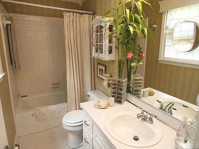 8700 West Lake Court Raleigh, NC 27613 - Photo 9 of 12 a bathroom with a sink toilet and shower
