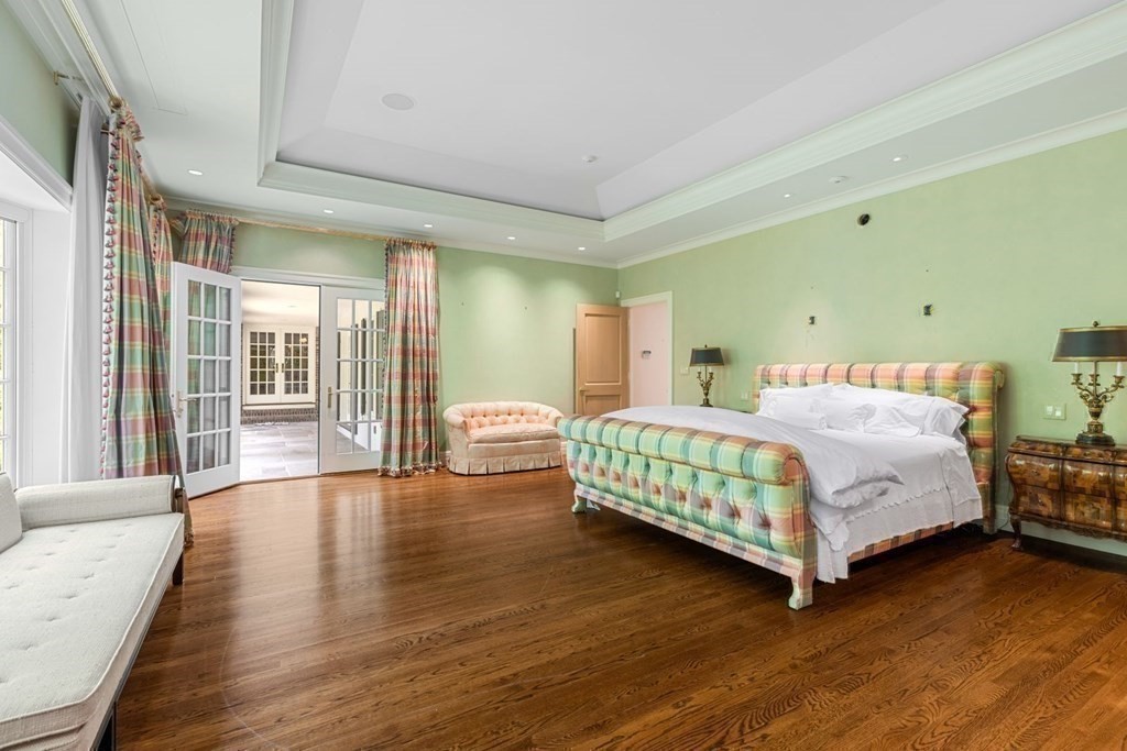 25 Bullard Road Weston, MA 02493 - Photo 19 of 31 a bedroom with a bed and wooden floor