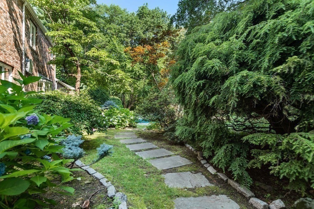 25 Bullard Road Weston, MA 02493 - Photo 26 of 31 a backyard of a house with lots of green space