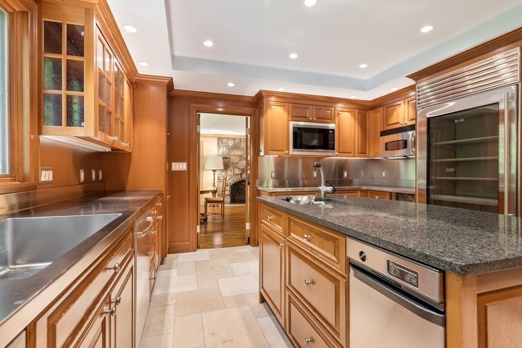 25 Bullard Road Weston, MA 02493 - Photo 10 of 31 a kitchen with stainless steel appliances granite countertop a sink and a stove