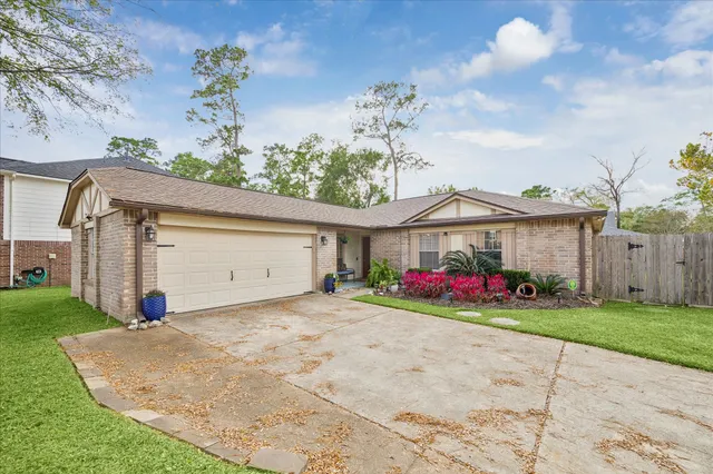 a view of a house with a yard and garage