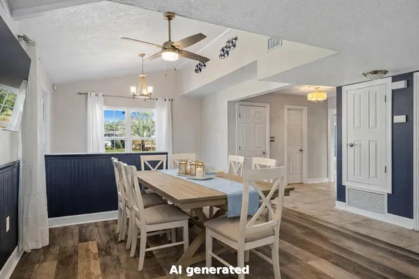 a kitchen with kitchen island granite countertop a table chairs sink and cabinets