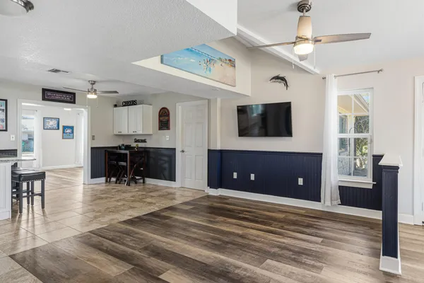 a kitchen with kitchen island granite countertop a table chairs sink and cabinets