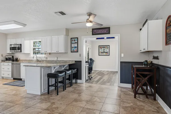 a kitchen with stainless steel appliances granite countertop a stove sink and cabinets