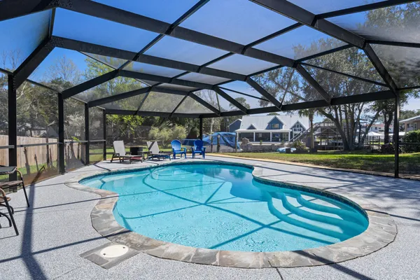 a view of a swimming pool with sitting area