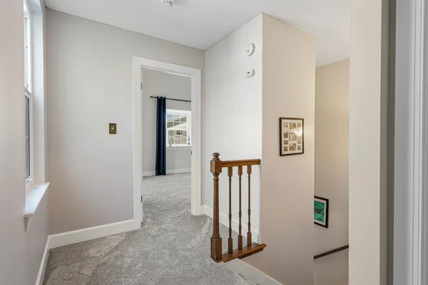 a spacious bedroom with a bed and a tv on the dresser