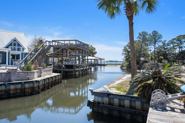 a view of a house with pool and ocean view