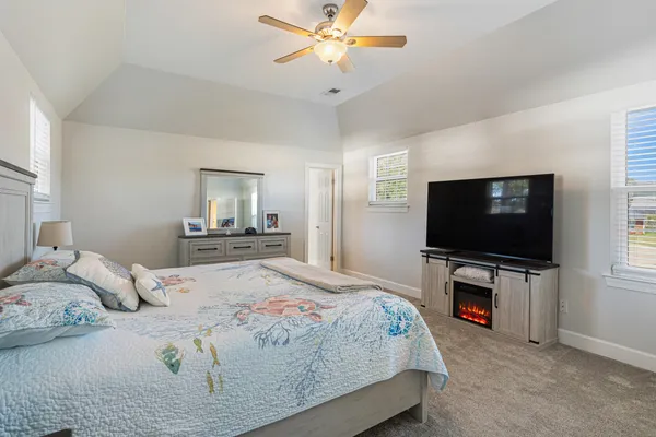 a living room with furniture a ceiling fan and a window